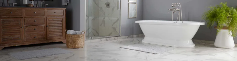 Light marble-look tile floor in a bathroom with a freestanding tub